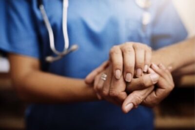 doctor holding patients hand